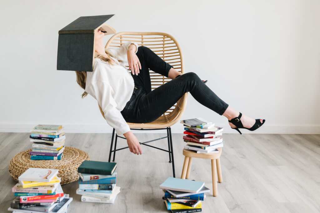 Sarah Klongerbo surrounded by books, representing brand voice ideas