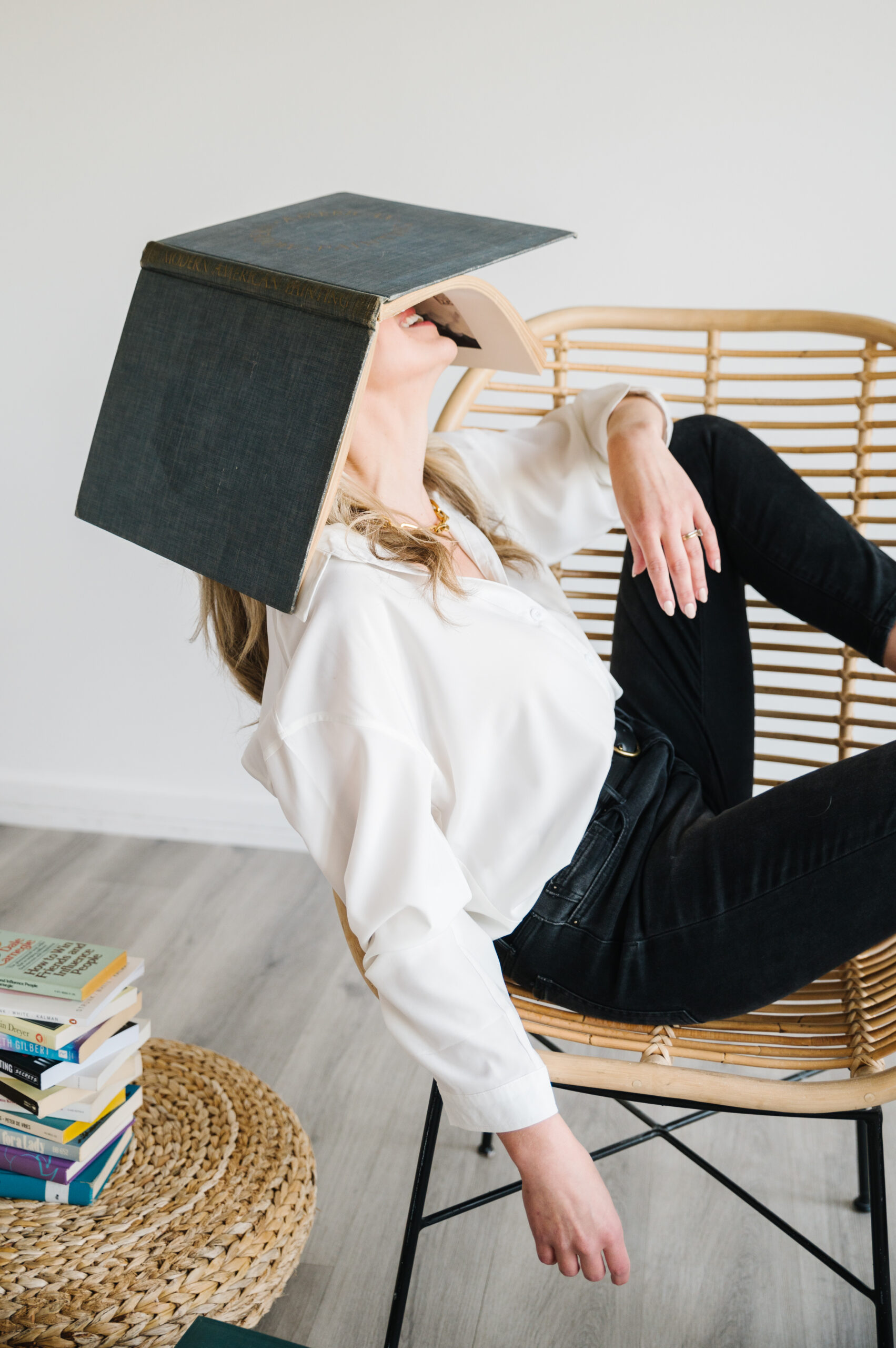 Sarah with book over her face in a chair