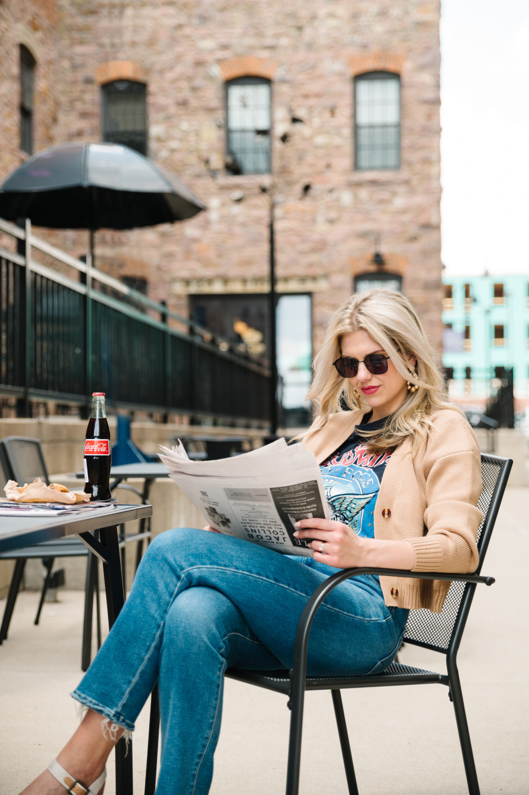 Sarah Klongerbo reading a newspaper, illustrating pricing and positioning strategies for creatives