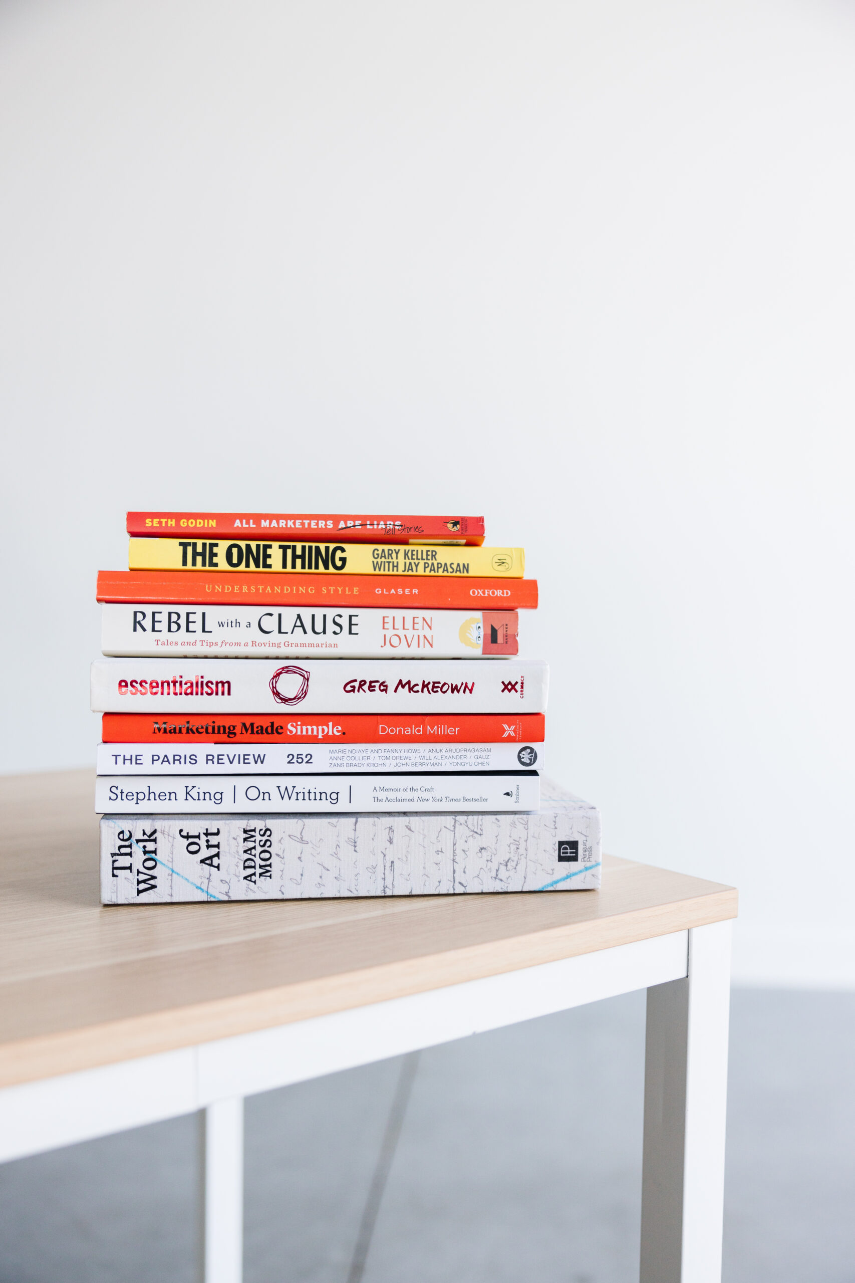 A stack of books on a desk, illustrating font psychology and why it's important to choose the right font for your copy
