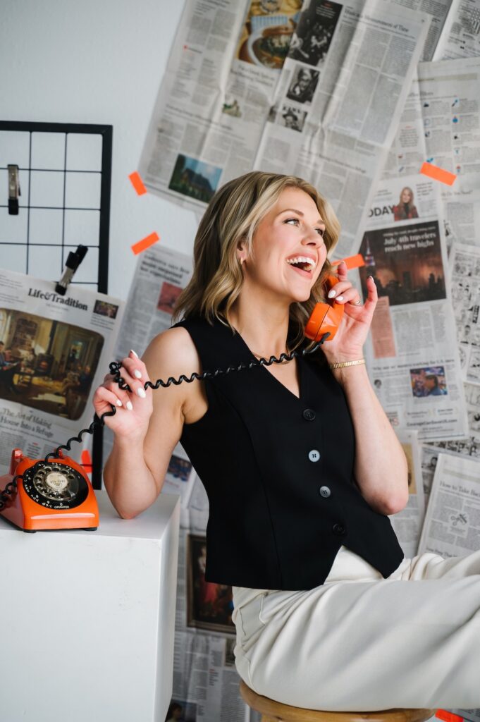 Sarah Klongerbo talking on an orange phone, exemplifying active voice in marketing copy