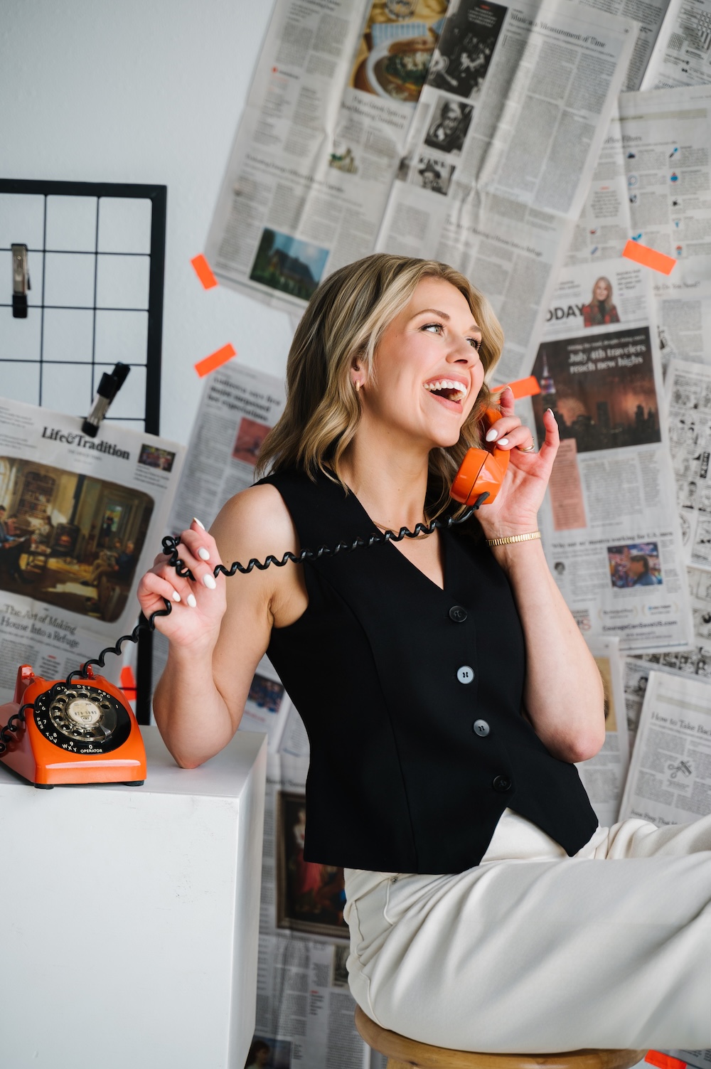 Sarah Klongerbo talking on an orange phone, exemplifying active voice in marketing copy